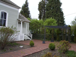 East side of St. Andrew's Anglican Church building showing the brick patio and trellis